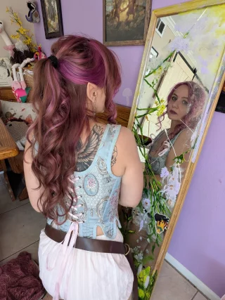 Helena Thistledown as an elf gazing into a magic mirror